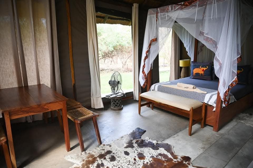 Comfortable safari lodge room prepared for guests